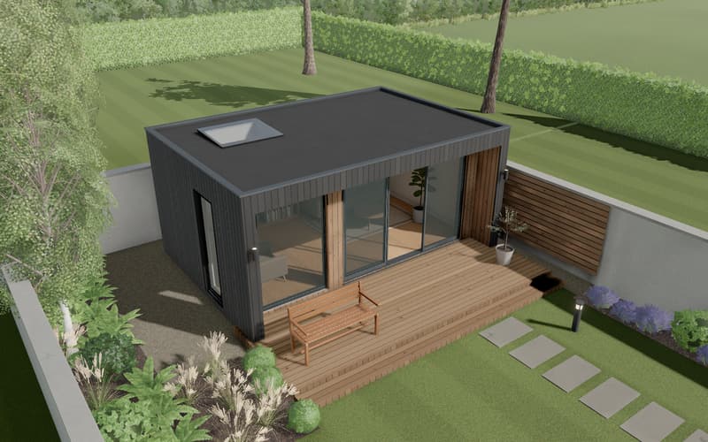The garden room sample, finished: a black-clad garden room with glass doors, a rooflight and a timber deck at the end of a back garden.