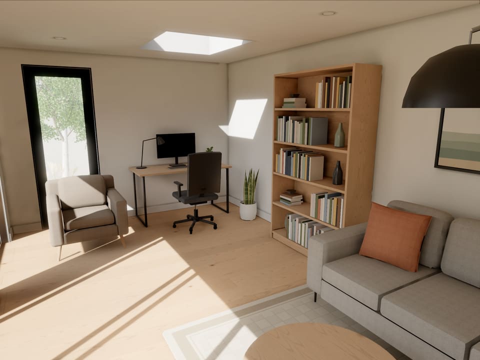 Inside the garden room sample, finished and furnished: an office and lounge with a desk, a bookcase and a sofa, the sun coming in through the glass doors.